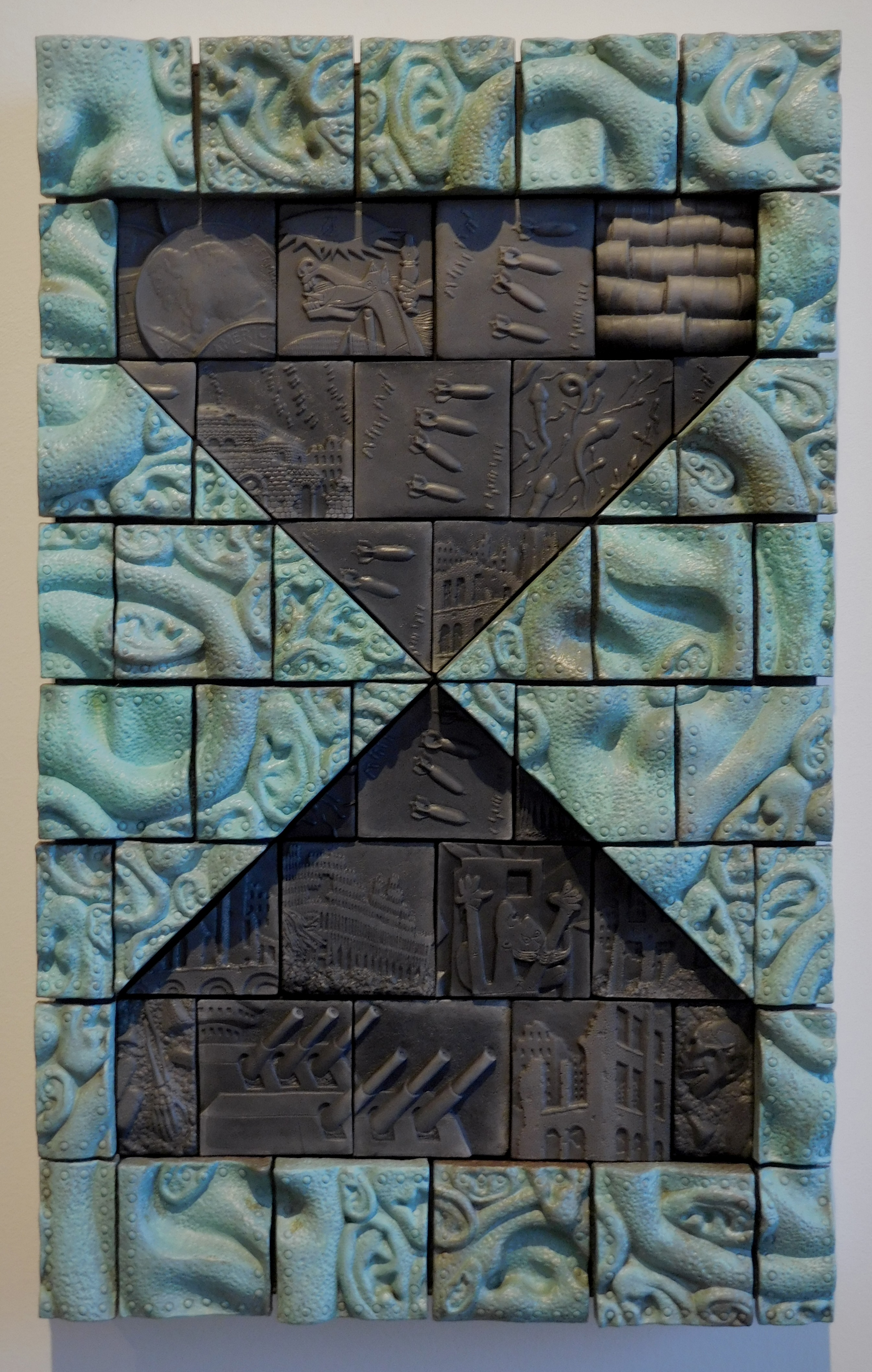 The Persistence of Folly, 2019, earthenware saggar-fired, copper patina, 23 x 14 x 2.5. Photo courtesy of Richard Notkin.