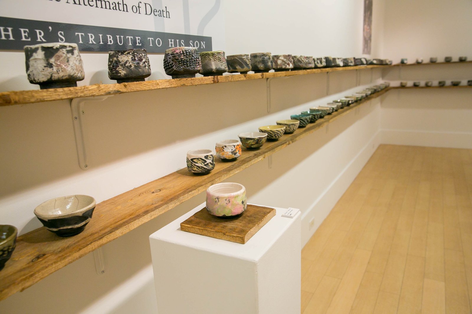 Installation photo with Kaddish Chawan 235/365, May 19, Jared’s Birthday in foreground. A Father’s Kaddish: The Celebration of (a) Life in the Aftermath of Death, Thrown 2005; glazed and fired 2015, each approx. 7.6 x 10.1 cm. Photo Credit: Steven Branfma