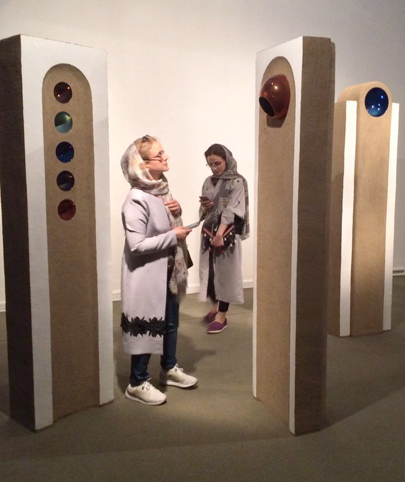 Jillian Echlin looking at artwork by Abbas Akbari: My city Kassan, Kah, Feshan, Kashan, 2017.  200x50x30 cm.