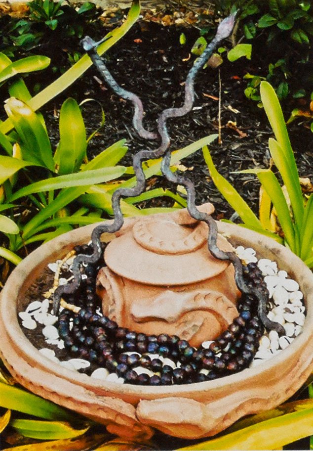 Osumare pot(s), Yoruba serpent deity, 2013. Unglazed earthenware, beads, shells, iron work, earth, bowl 15 in. Photograph by Awo Fáladé Òsúntólá. Osumare pot(s), Yoruba serpent deity, 2013. Unglazed earthenware, beads, shells, iron work, earth, bowl 15 in. Photograph by Awo Fáladé Òsúntólá.
