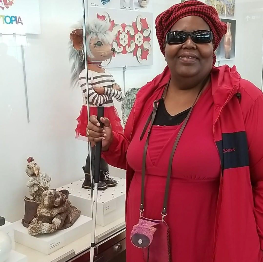 Donna Ray in front of her work on display in Terminal 2 at the Minneapolis-St. Paul International Airport where the MNWCA had works exhibited during the 2019 NCECA conference.