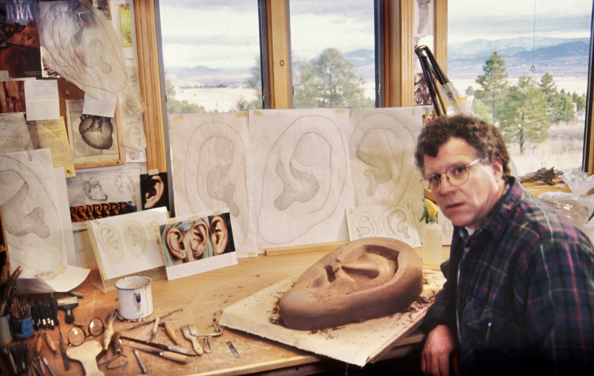 Richard Notkin in Helena, MT studio carving clay ear prototype models for "Legacy", 1998. Photo courtesy of Richard Notkin. Richard Notkin in Helena, MT studio carving clay ear prototype models for "Legacy", 1998. Photo courtesy of Richard Notkin.