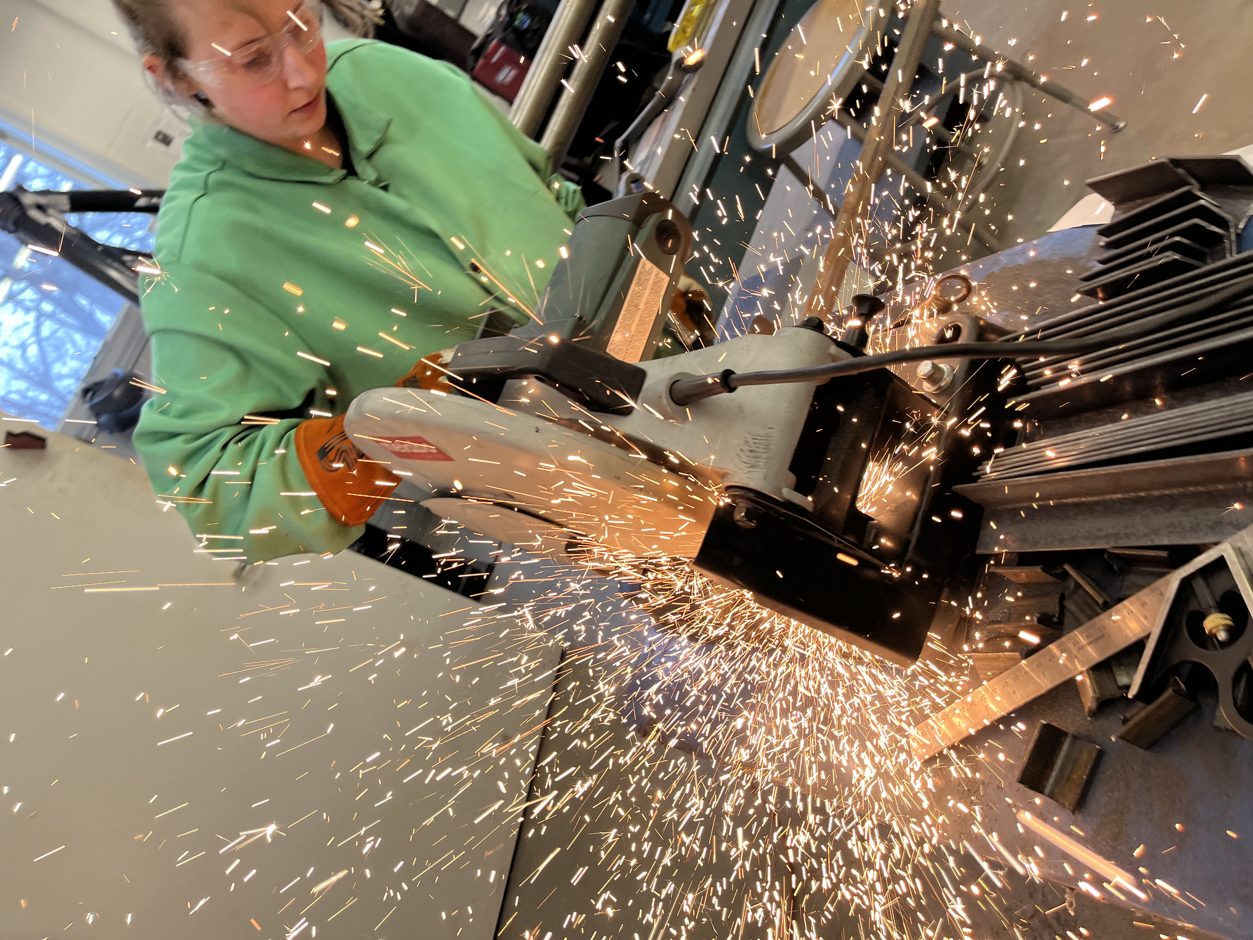 Student cutting steel.